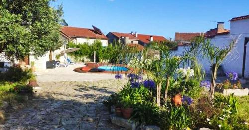 a yard with a swimming pool and some plants at Louro's Villa - 12130AL in Cantanhede
