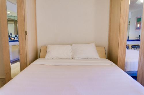 Ένα ή περισσότερα κρεβάτια σε δωμάτιο στο Kuhio Banyan Hotel (with Kitchenettes)