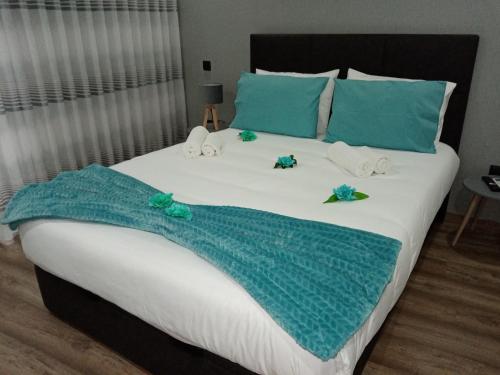 a large bed with a blue towel on it at O Salgueiro in Melo
