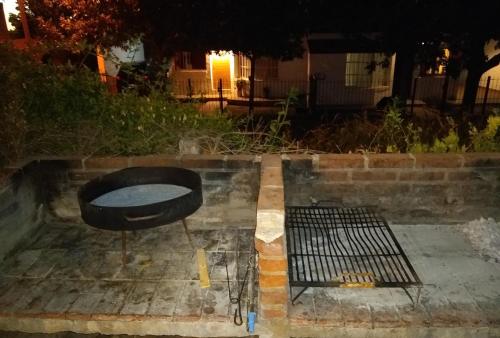a grill sitting on the side of a street at Complejo Viejo Sulky in Mina Clavero