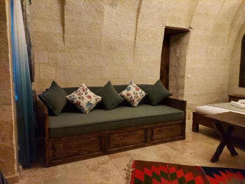 a couch with pillows on it in a room at ARMEsos Cave Hotel in Urgup