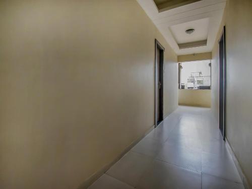 an empty corridor with a door in a building at Aasra Lodge in Ratnagiri