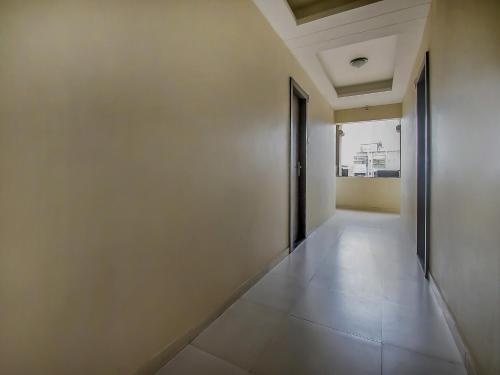 an empty corridor with a door in a building at Aasra Lodge in Ratnagiri