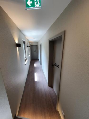 a hallway with a long hallway leading into a room at Wirtshaus & Hotel Zur Alten Brauerei Zapf in Uettingen