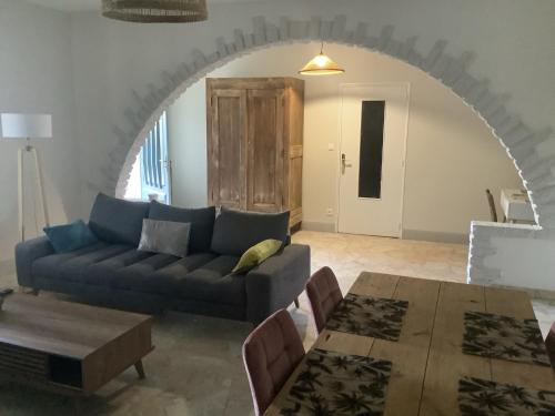 a living room with a couch and a table at Jolie Appartement à la campagne in Hautesvignes