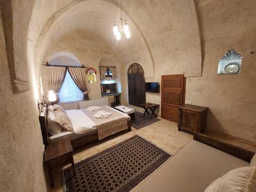 a bedroom with a bed in a large room at ARMEsos Cave Hotel in Ürgüp