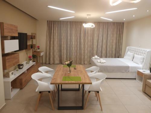 a living room with a bed and a table and chairs at Amazing Apartments @ Monastiraki Subway Station in Athens