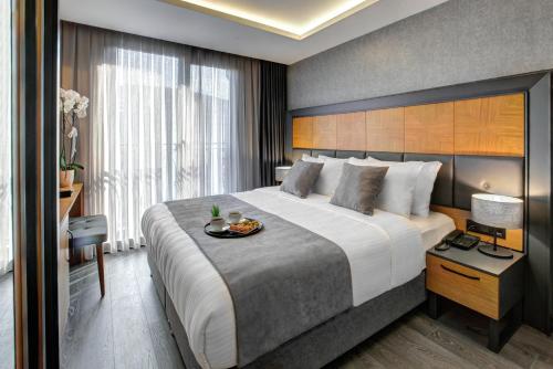 a hotel room with a large bed with a tray on it at No12 Hotel Sultanahmet in Istanbul