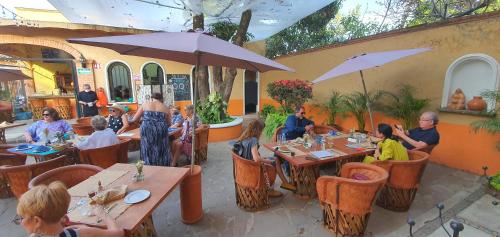 a group of people sitting at tables in a restaurant at Hotel Boutique Sol y Luna SPA in Ajijic