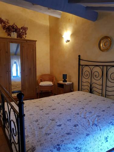 a bedroom with a bed and a chair and a window at Maison Dina in Collepardo