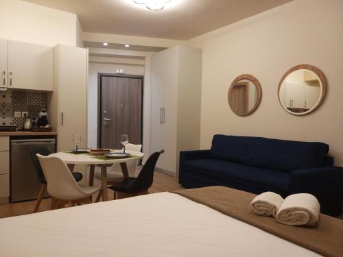a living room with a blue couch and a table at Amazing Apartments @ Monastiraki Subway Station in Athens
