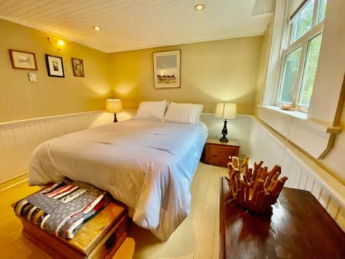 a bedroom with a large white bed and a window at Unique Stay! Converted Church In Idyllic Location in St. John's
