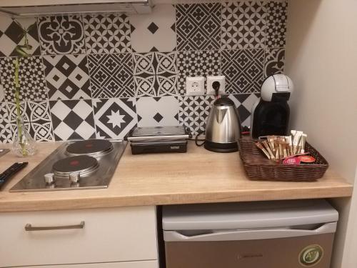 a kitchen with a counter with a sink and a stove at Amazing Apartments @ Monastiraki Subway Station in Athens