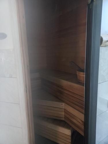 a closet with wooden steps in a room at Tamula apartament in Võru