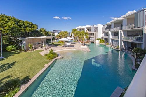 a swimming pool in the middle of a building at Drift Apartments - Tweed Coast Holidays ® in Kingscliff