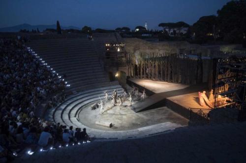 a crowd of people sitting in a amphitheater at night at Pompei Luxury Suite in Pompei