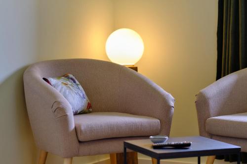 a living room with a chair and a lamp at Landhäuschen Anderswo in Bocholt