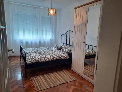 a bedroom with a bed and a large window at Babalina's Place in Bihać