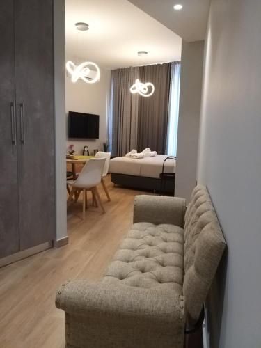 a living room with a couch and a bedroom at Amazing Apartments @ Monastiraki Subway Station in Athens