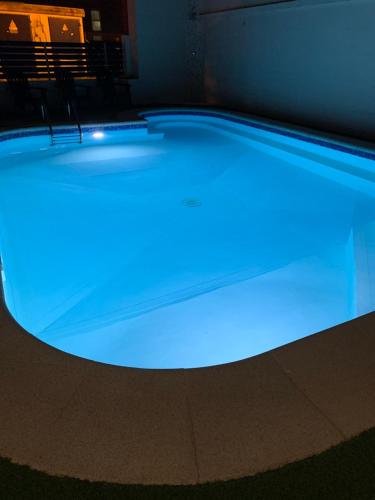 a swimming pool with blue lights on it at Hotel Spa Pinar del Mar in Platja  d'Aro
