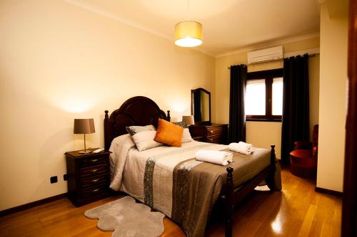 a bedroom with a bed with two towels on it at Charming Family Large Apartment in Bragança