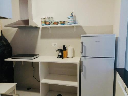 a small kitchen with a white refrigerator and a counter at Il Balconcino delle Cinque Terre in Vernazza