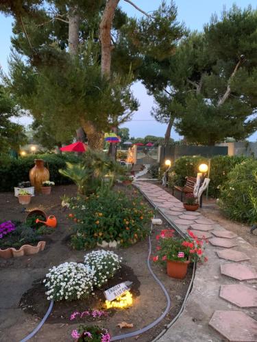 a garden with flowers and a pathway at Villa Anna GuestHouse in Brindisi