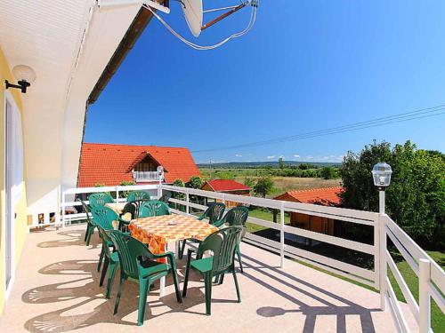 a patio with a table and chairs on a balcony at Holiday home in Balatonlelle 40449 in Balatonlelle