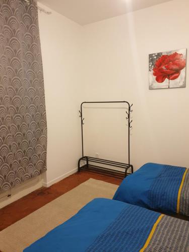 a bedroom with a bed and a towel rack at Appartement Picasso centre historique Perpignan in Perpignan