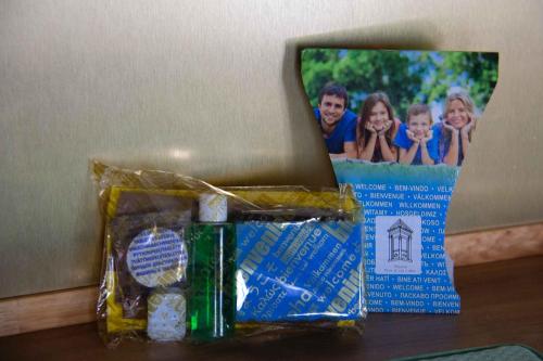 a table with a gift bag and a picture of a family at Apartamentos Tres Llaves Palacio de Vela de los Cobos in Úbeda