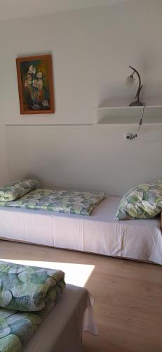 a room with two beds and a picture on the wall at Pod Modrzewiami in Milówka