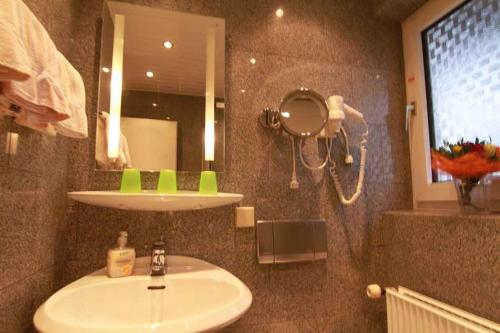 a bathroom with a sink and a mirror at Apartments in Westerland/Sylt 38535 in Westerland