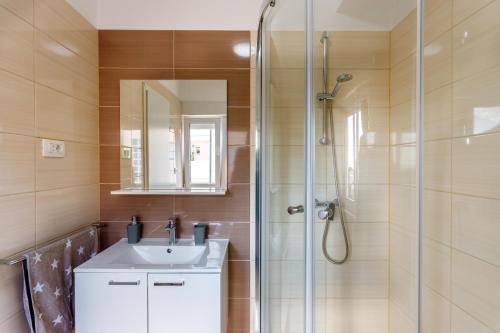 a bathroom with a sink and a shower at Luxury apartments Budimir in Podstrana