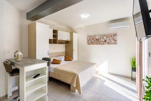 a bedroom with a bed and a desk at Luxury apartments Budimir in Podstrana