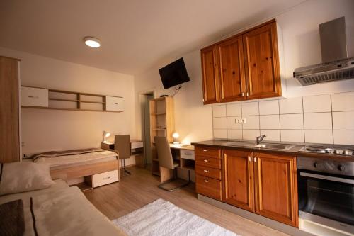 a kitchen with a couch and a table in a room at MARIBOR CITY CENTER MINIDORM APARTMENT in Maribor