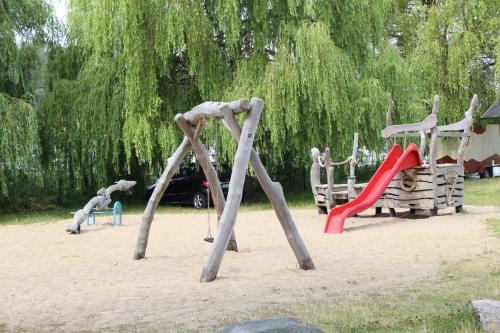 a playground with two slides and a swing at Apartment in Sellin/Insel Rügen 37917 in Sandort