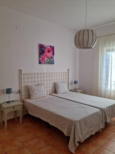 a bedroom with a large bed and a painting on the wall at Mar in Isla del Moral