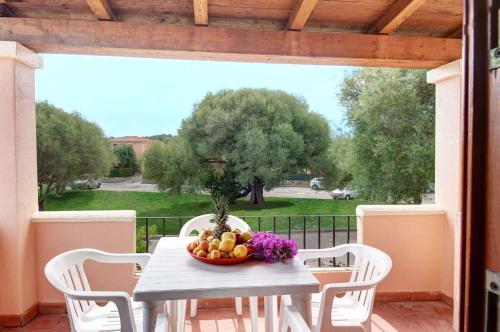 a table with a bowl of fruit on a patio at Holiday home in San Teodoro 26875 in San Teodoro