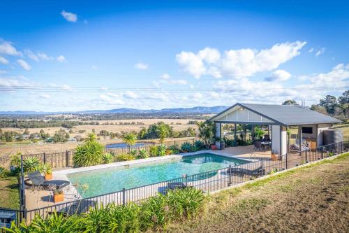 an estate with a swimming pool and a gazebo at Sovereign Hill Country Lodge in Rothbury