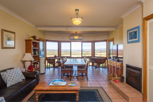 a living room with a couch and a table at Sovereign Hill Country Lodge in Rothbury