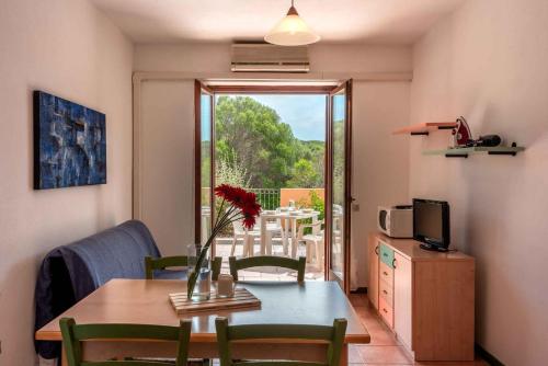 a living room with a table and chairs and a window at Holiday home in Santa Teresa di Gallura 27331 in Santa Teresa Gallura