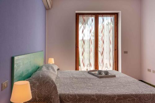 a bedroom with a bed and a window at Holiday home in Santa Teresa di Gallura 27331 in Santa Teresa Gallura