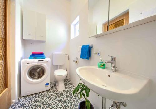 a bathroom with a washing machine and a sink at Apartment in Vrbnik/Insel Krk 35995 in Vrbnik