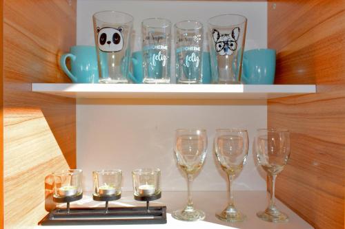 a bunch of wine glasses sitting on a shelf at MaC Patagonia in San Carlos de Bariloche
