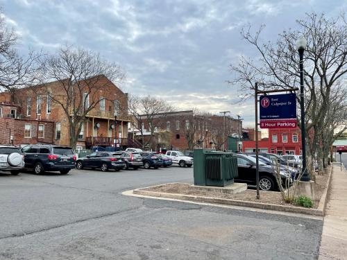 a parking lot with cars parked in a city at Culpeper Center Suites in Culpeper