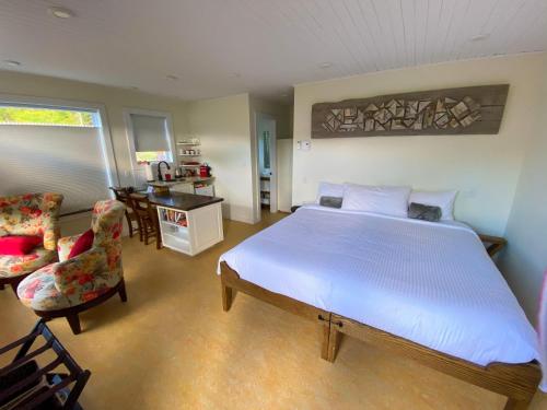 a bedroom with a bed and a living room at The Rooms at Woody Point in Bonne Bay