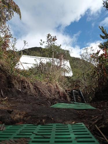 a set of stairs on a hill with a building at Cabañas el Paraiso Sesquile in Sesquilé