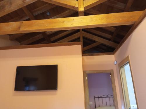 a living room with a flat screen tv on the wall at Casa la ti María la viuda in Riego de Lomba