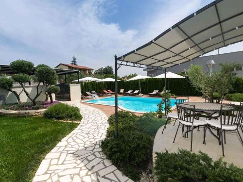 a patio with a table and a pool at Apartment in Nova Vas - Istrien 35437 in Nova Vas