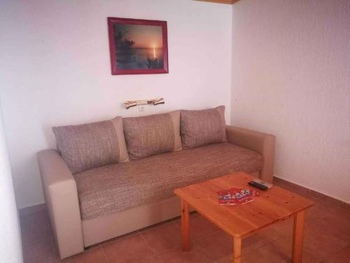 a living room with a couch and a table at Apartment Balatonvilagos - Balaton 30360 in Balatonaliga